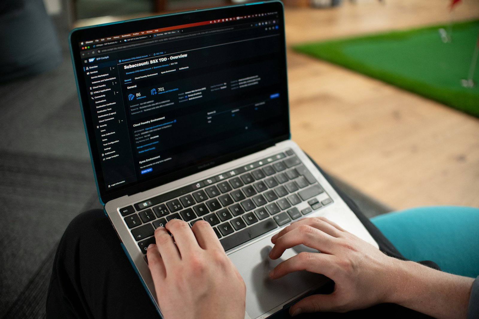 Hands typing on a laptop showing a marketing performance dashboard